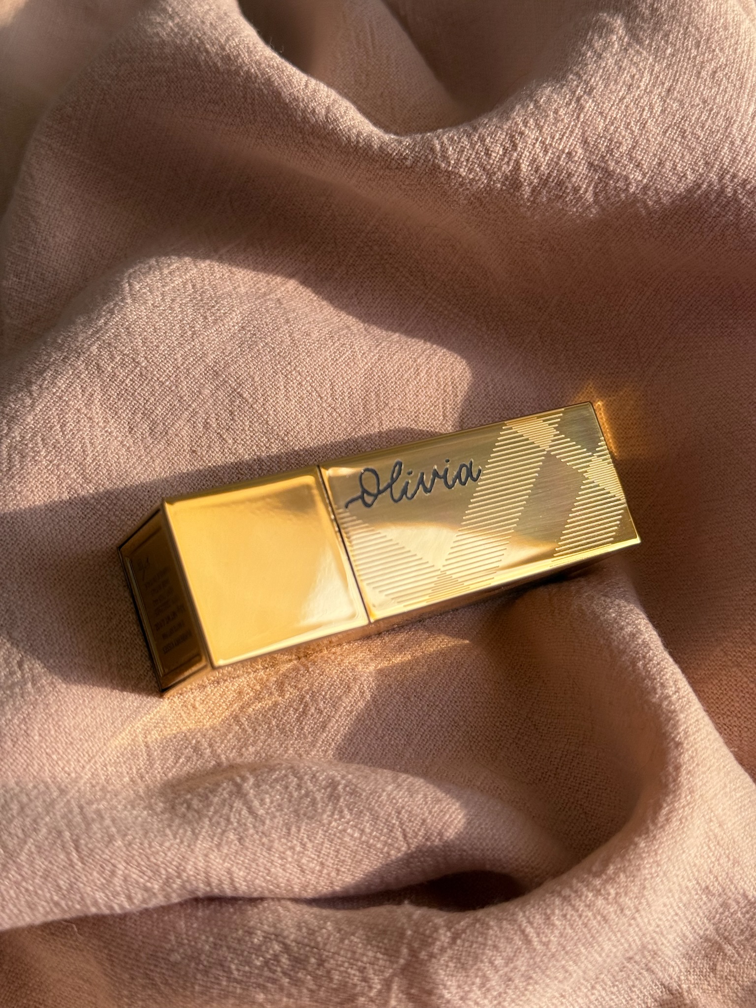 Burberry gold check-pattern lipstick case with calligraphed name