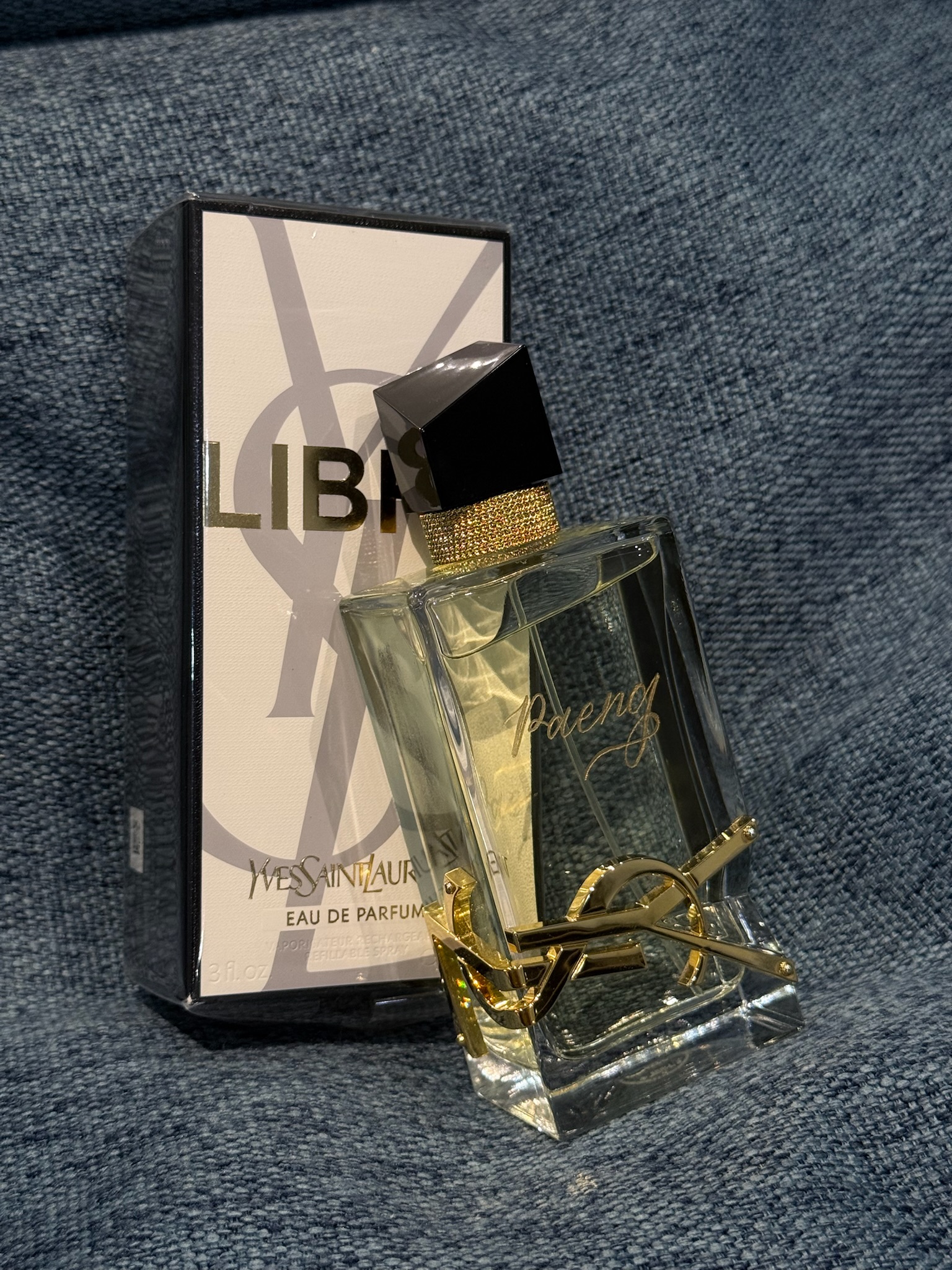 YSL Libre perfume bottle with calligraphed name beside Libre box