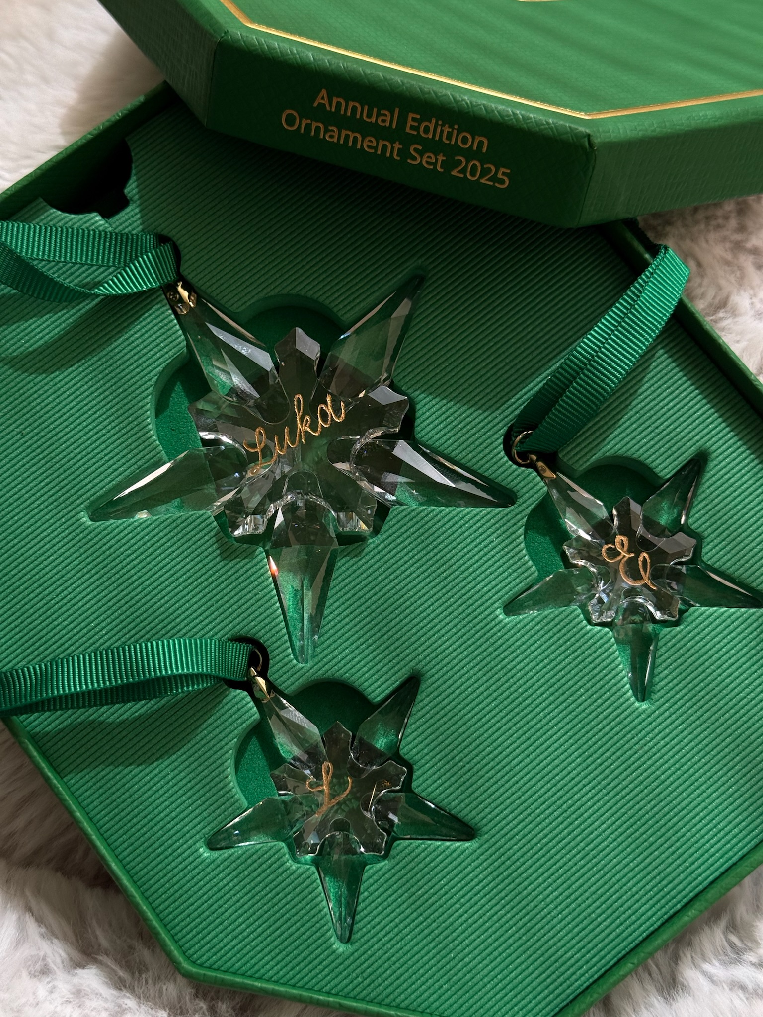 Three engraved Swarovski Annual Edition Ornament Set 2025 green crystal stars in presentation box