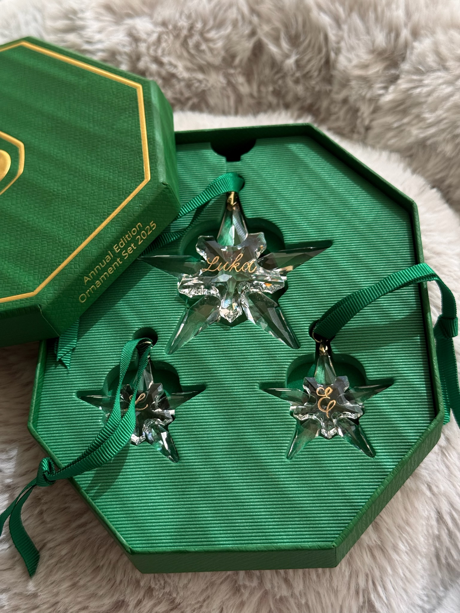 Swarovski Annual Edition Ornament Set 2025 — three green crystal stars with engraved names in emerald box